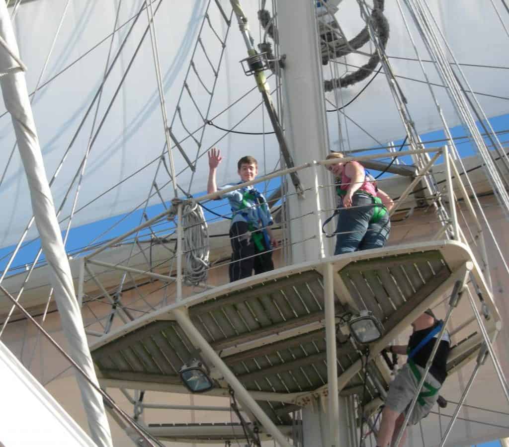 Waves from the fighting tops aboard Tenacious. Climbing the mast is a great challenge for people of all abilities.