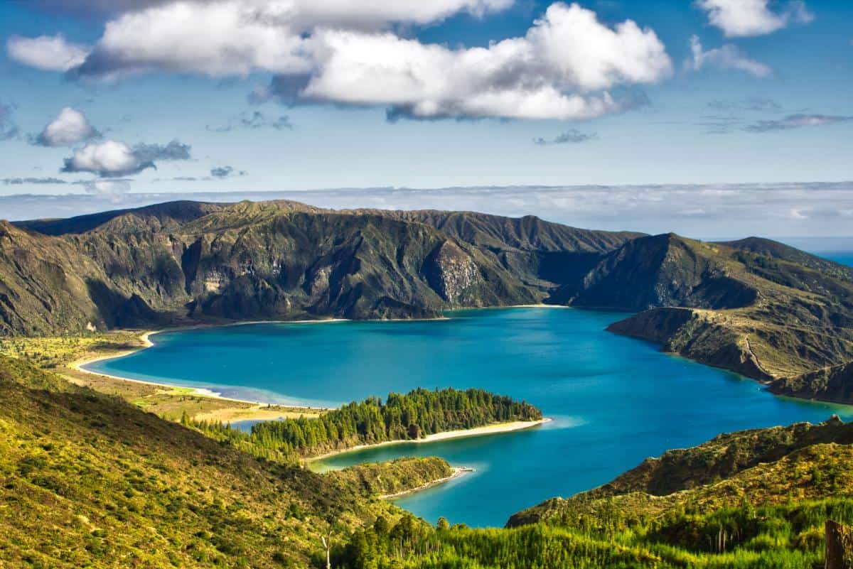 Explore lakes and waterfalls ashore and sail between islands of the Azores