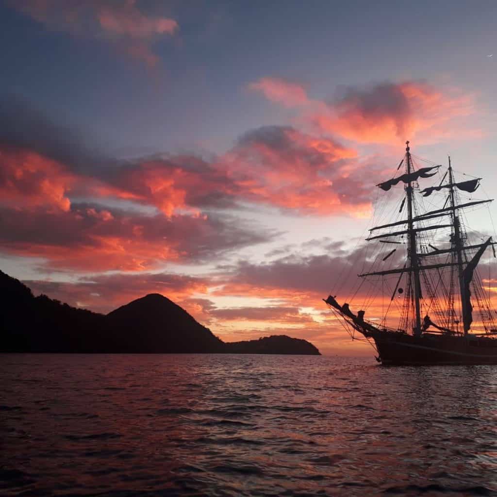 Eye of the Wind - anchored in the sunset with pink sky. Traditional sailing holidays with classic sailing