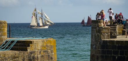 Anny sailing off a historic harbour in the West Country