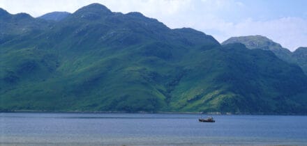 Looking across Loch Hourn to the mountains of Knoydart with a fishing boat in the foreground