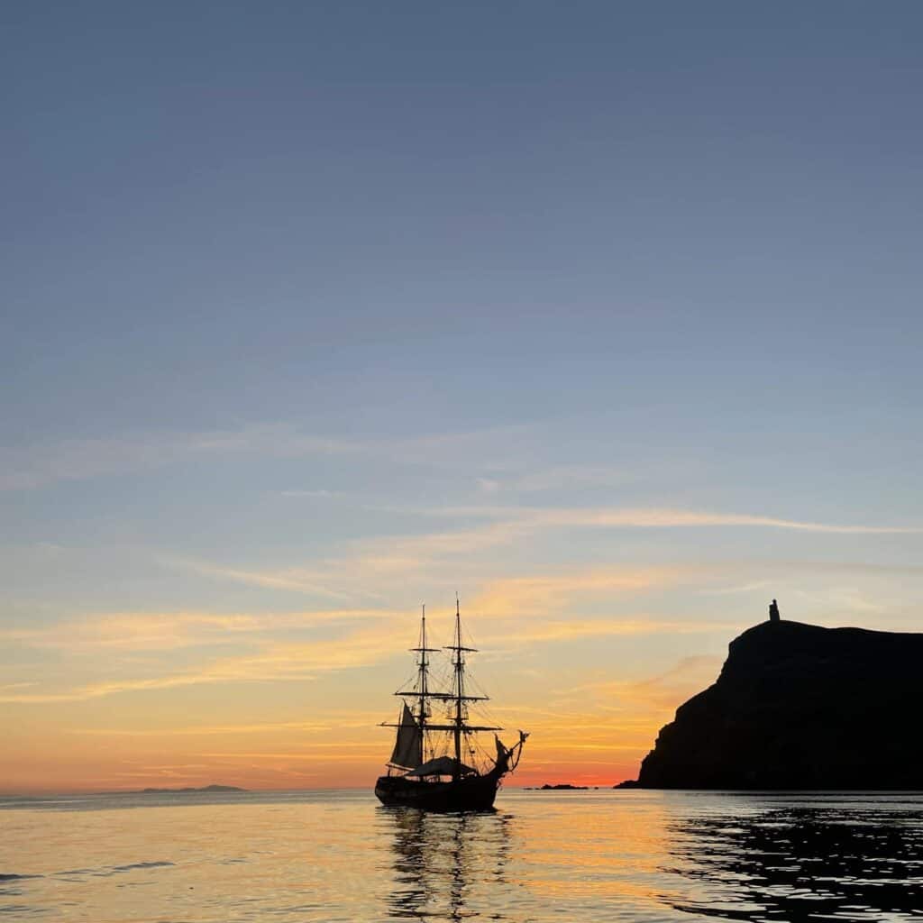 Tallship Phoenix anchored in the sunset. Adventure sailing holidays with classic sailing.