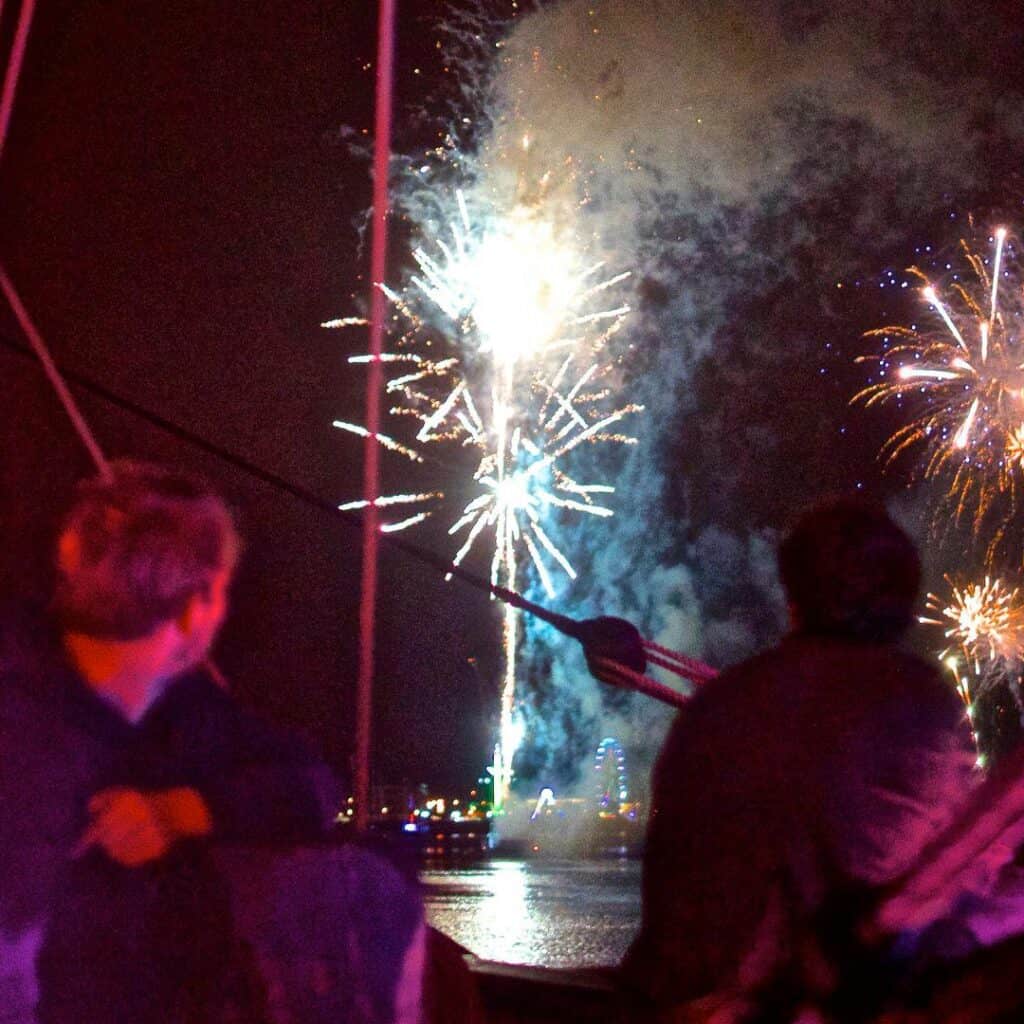 Phoenix crew watching fireworks. Festival voyages and hands on adventures with classic sailing