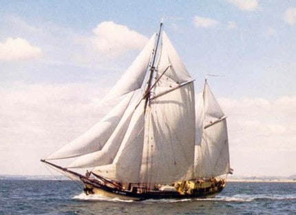 Historic photo of Dutch sail cargo ship De Tukker under full sail