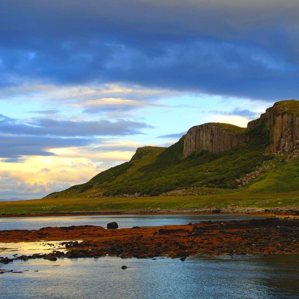 the coastline of Skye in golden light. Fantastic Hebridean sailing with Classic Sailing