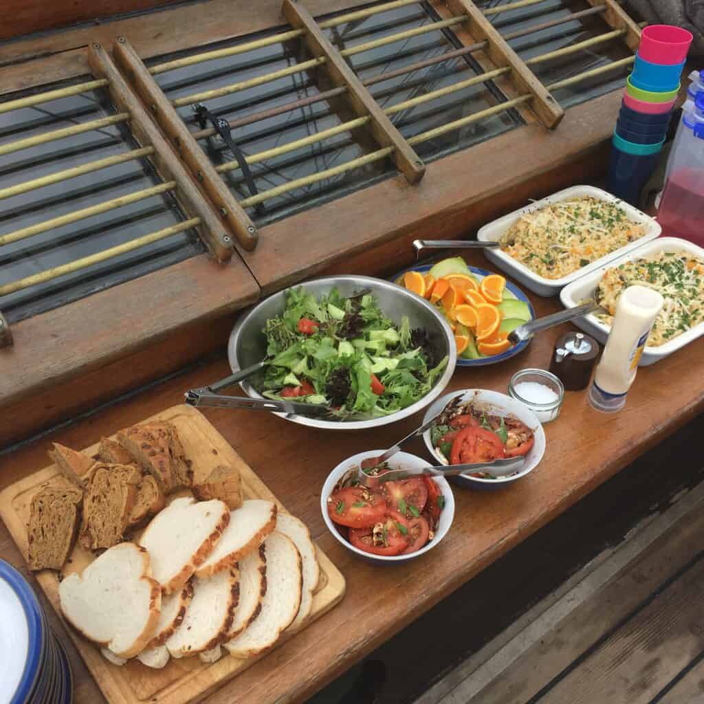 Buffet lunch laid out on the deck of Leader. Enjoy relaxing sailing adventures with Classic Sailing