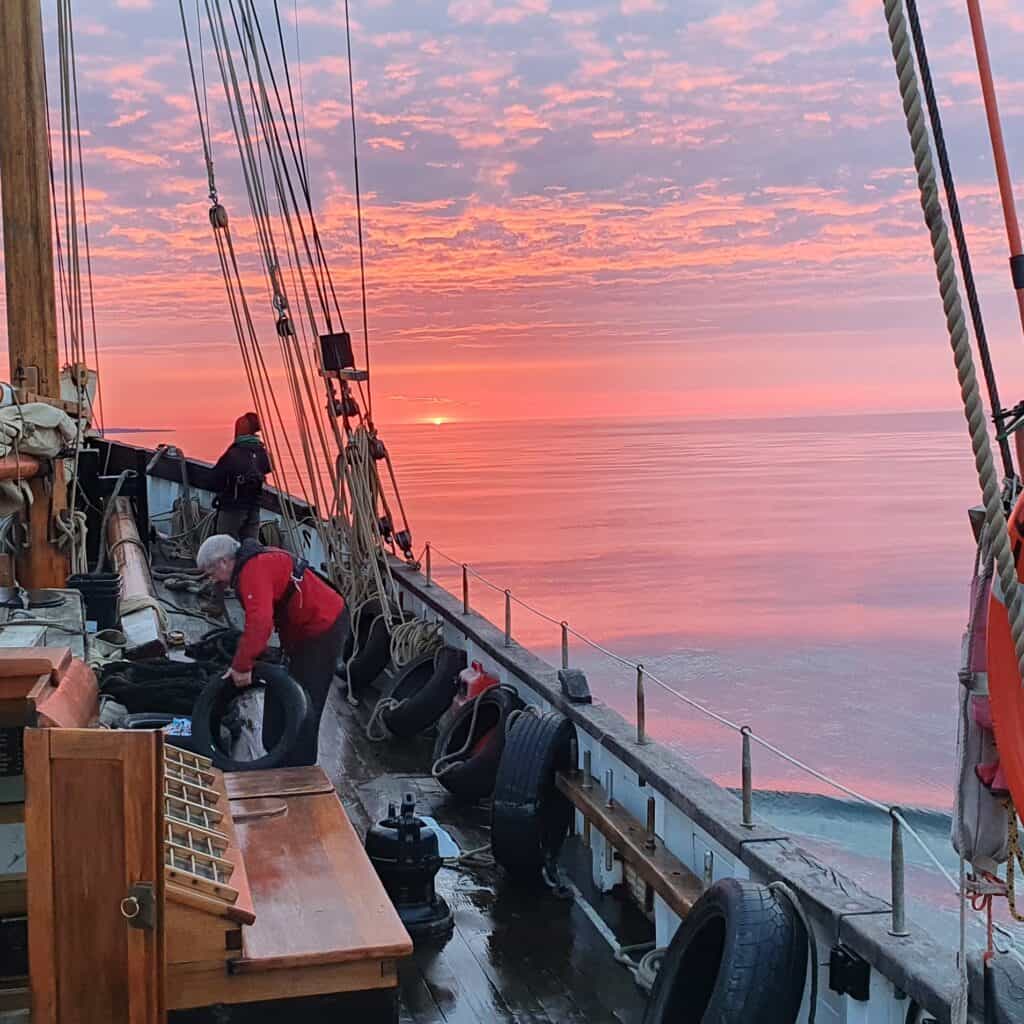 Sunset over the sea, the view from the deck of heritage sailing ship Leader