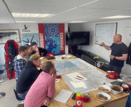 Polar explorer Jim McNeill leads an Ocean Warrior planning session. Join the expedition through Classic Sailing