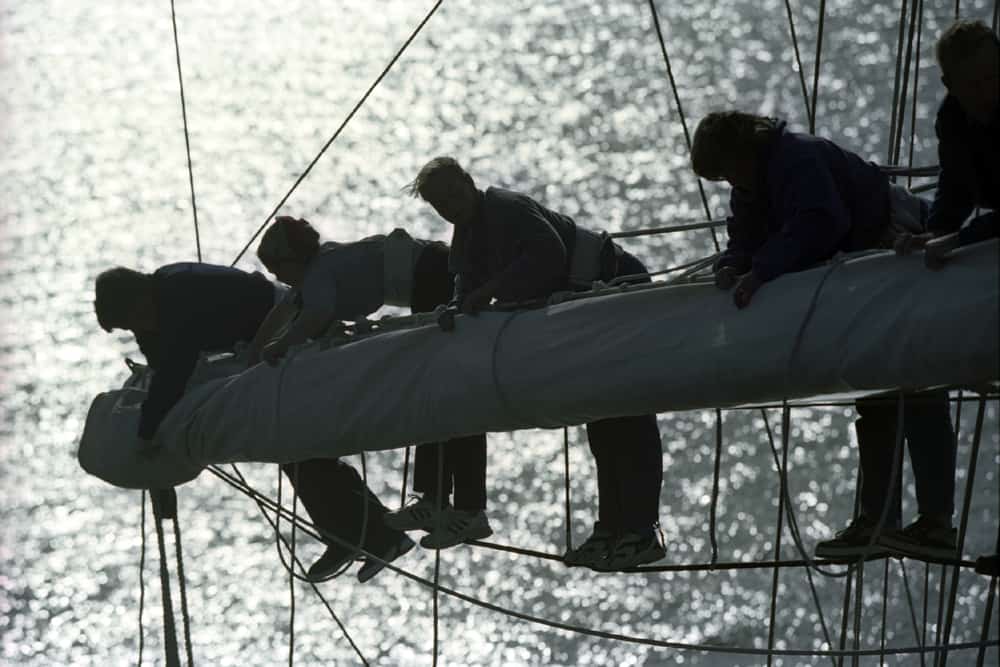 Stowing sails aloft on Tenacious. A tall ship built for able bodied and disabled crews. Photo tallshipstock.com