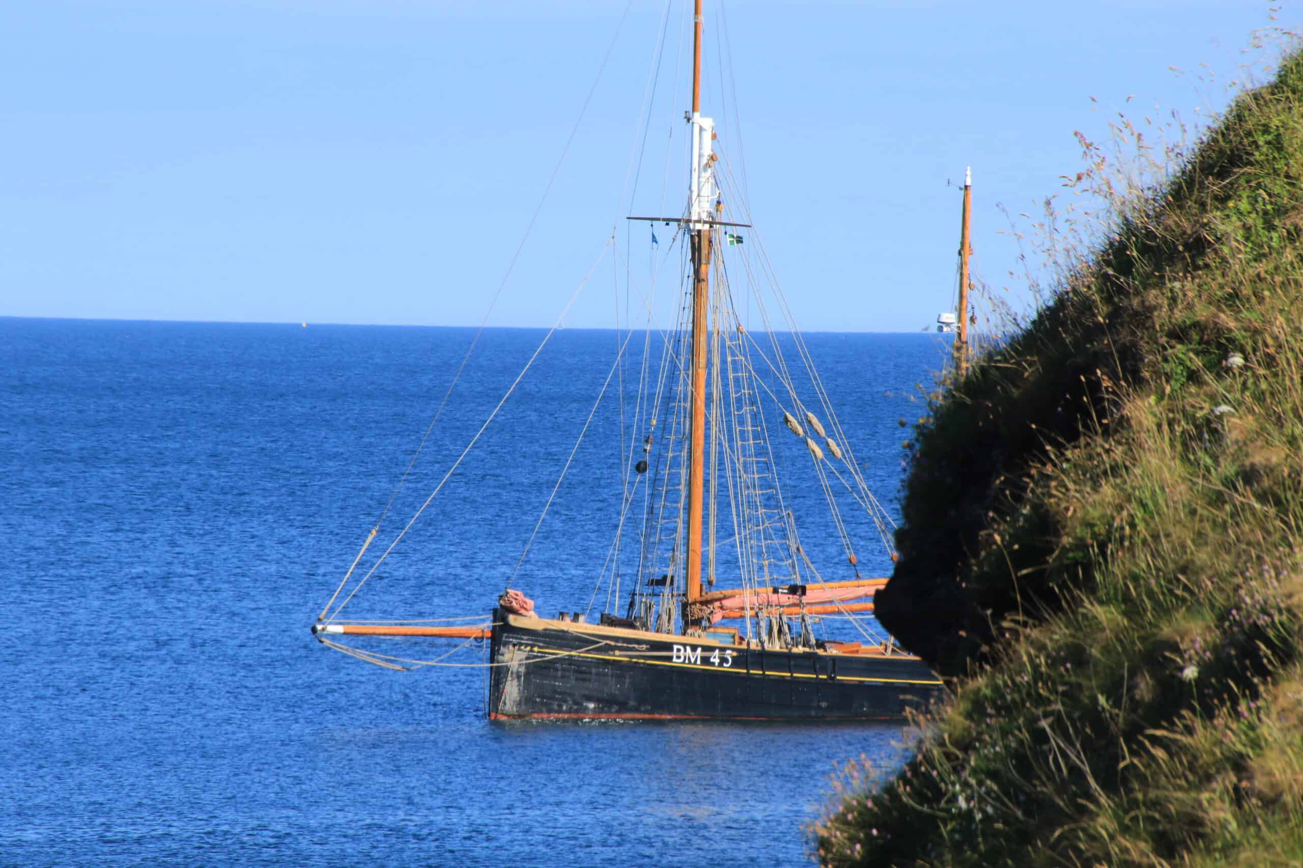 Brixham trawler Pilgrim anchored off the coast